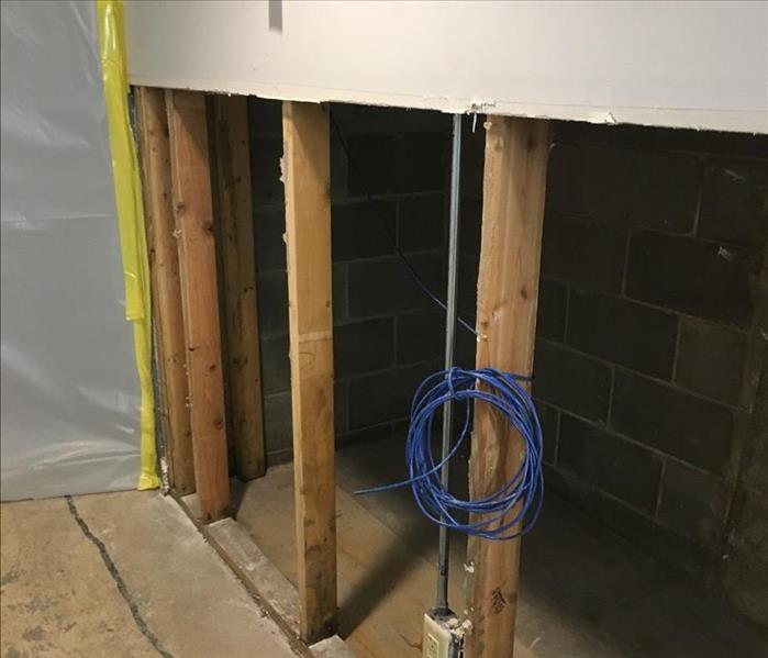 The walls of the basement have been cut up to where the water line ends and the framing is exposed